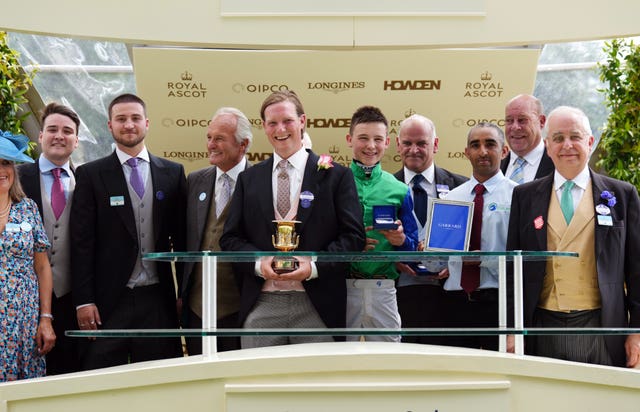 Sam Sangster (centre) collects the trophy with connections at Royal Ascot