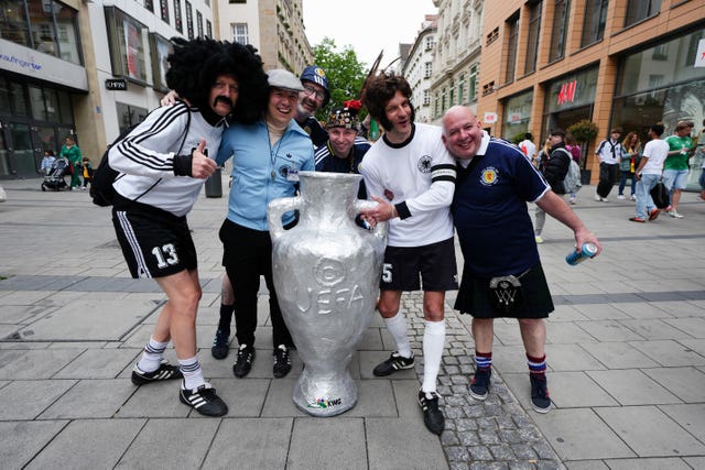 Scotland and Germany fans pose for a photo with a replica trophy