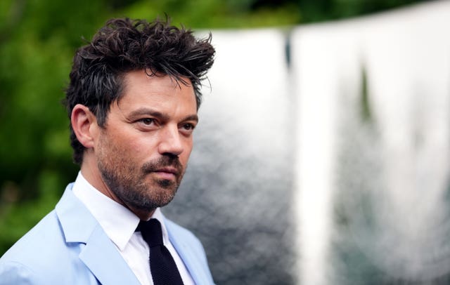 Head and shoulders photo of Dominic Cooper, in suit and tie