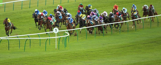 Lord North and Frankie Dettori (blue and white colours) poised to strike in the Cambridgeshire