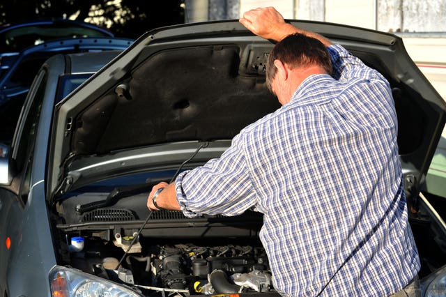 A man carries out car maintenance