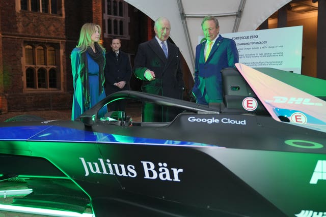 Charles looking at a Formula E car with SMI chief executive Jennifer Jordan-Saifi (left) and Dr Andrew Forrest executive chairman and founder of Fortescu