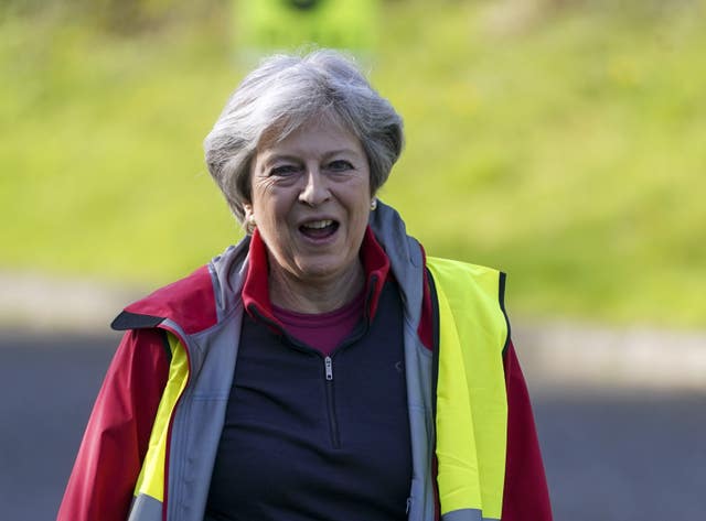 Former prime minister Theresa May acts as a marshal during the Maidenhead Easter 10K race