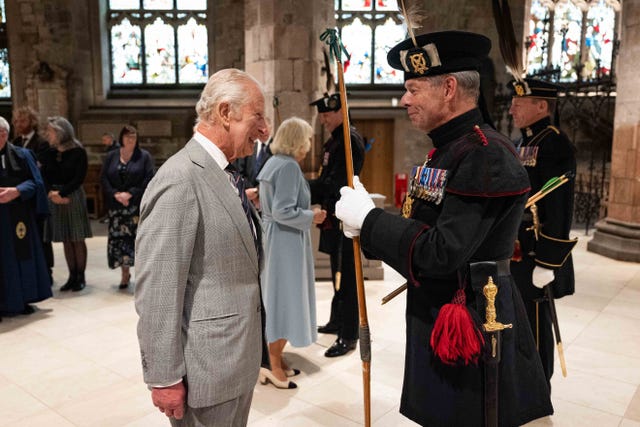 King speaking to uniformed man
