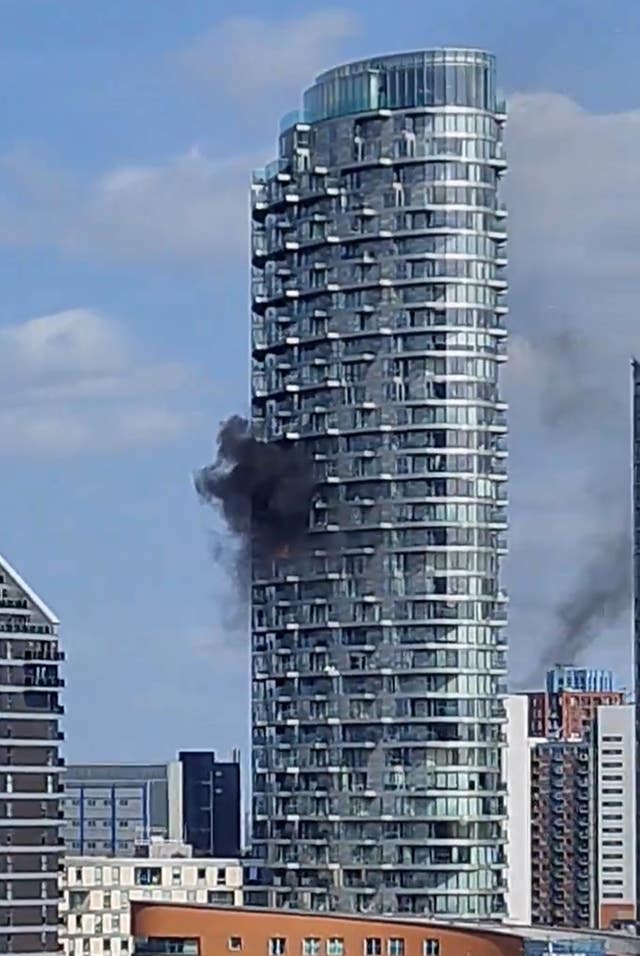 The tower block in New Providence Wharf with smoke billowing from it