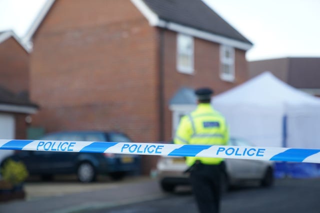 Police outside a house in Costessey near Norwich after four people were found dead inside the property. 