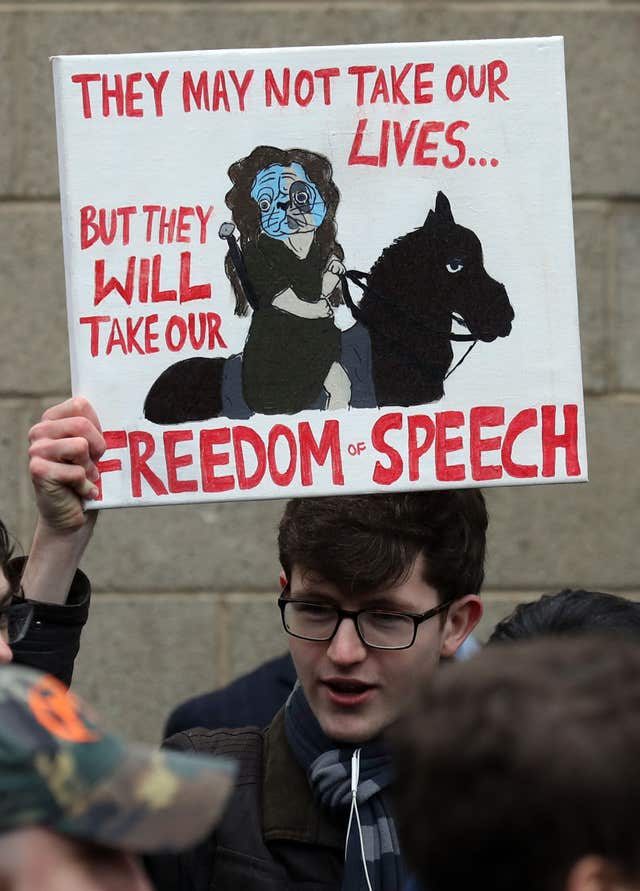 A supporter holds a poster defending freedom of speech outside Airdrie Sheriff Court (Andrew Milligan/PA)