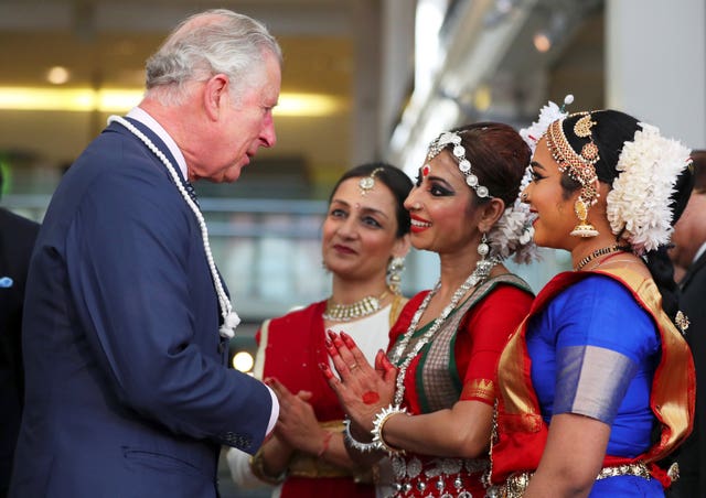 Charles greets dancers from the Akademi South Asian group (Hannah McKay/PA)