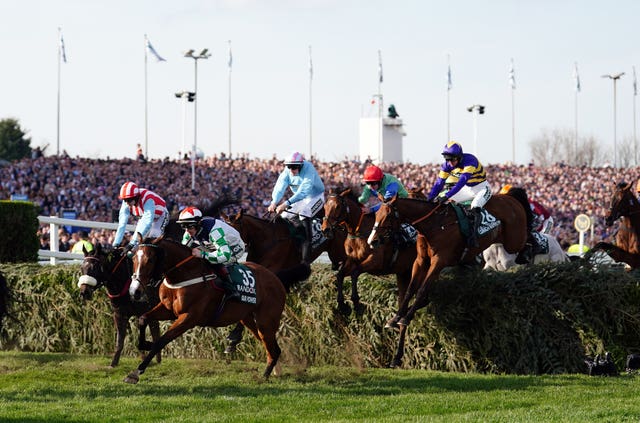 Mr Incredible (pale blue, centre) jumps a fence during the Randox Grand National 