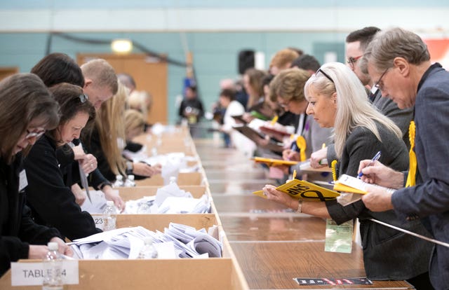 Party observers record votes as ballot boxes are opened at The Leisuredrome in Bishopbriggs for the East Dunbartonshire 2019 General Election count