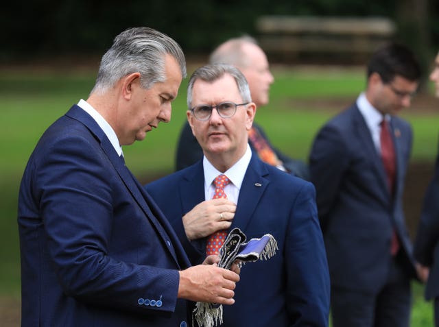 Former Democratic Unionist Party leader Edwin Poots talks with the man who replace him, Sir Jeffrey Donaldson during a Battle of the Somme commemoration 