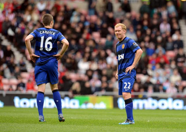 Manchester United’s Michael Carrick and Paul Scholes, right, stand dejected at the Stadium of Light after news of Manchester City's late title-winning goal in 2012
