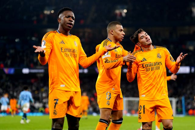 Real Madrid's Vinicius Junior, Kylian Mbappe and Brahim Diaz, left to right, celebrate Brahim's goal against Manchester City