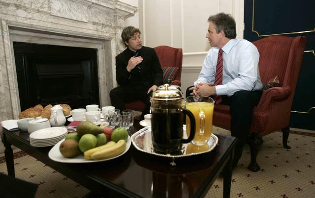 Celebrity TV chef Jamie Oliver speaks to then-prime minister Tony Blair (right) after delivering a petition demanding better food for pupils