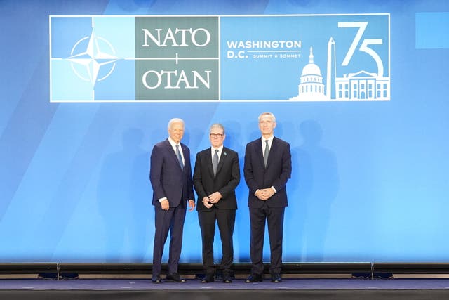 Joe Biden, left, posing for photos with Sir Keir Starmer, centre, and Jens Stoltenberg