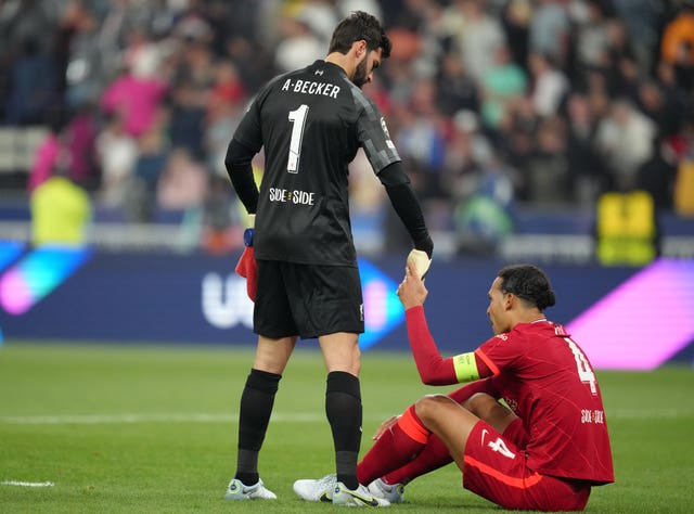 Liverpool keeper Alisson Becker, left, consoles Virgil van Dijk after the final whistle at the Stade de France