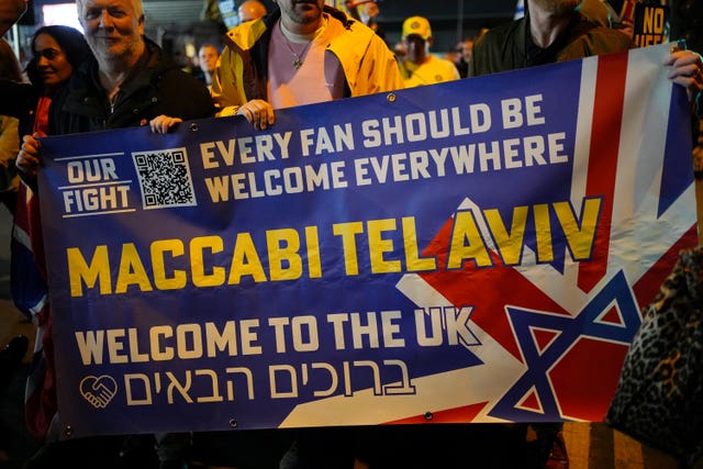 People on a march holding a sign reading 'Every fan should be welcome everywhere, Maccabi Tel Aviv welcome to the UK'