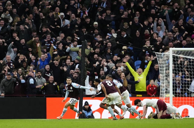 Emiliano Buendia, left, and Aston Villa celebrates their late winner against Arsenal