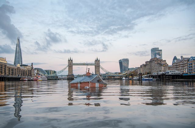 The Sinking House on the Thames next to Tower Bridge