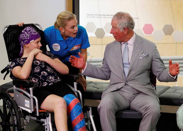 Charles chats to Abigail Head, a Juiced TV star and hospital patient, and Philippa Russell, founder of Juiced TV (Phil Noble/PA)
