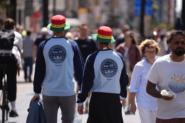 Oasis fans wearing merchandise from the band's collaboration with Adidas