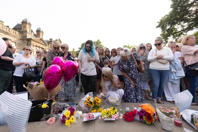 Members of the public taking part in a vigil