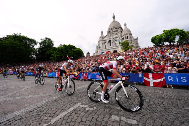 Riders passing Basilique du Sacre Coeur de Montmartre 