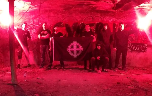 Benjamin Hannam, second right, posing with men holding a Celtic Cross flag (Metropolitan Police/PA)