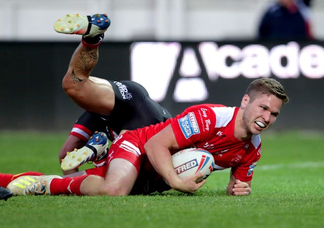 Matt Parcell, with the ball under his right arm, slides in to score a try