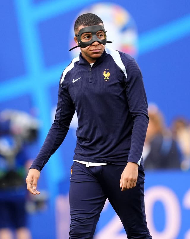 Kylian Mbappe training in a protective mask