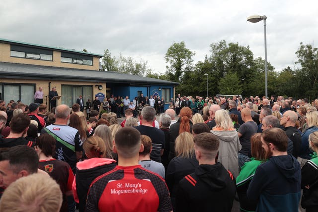 People attend a vigil for shooting victims Vanessa Whyte, 45, and her children James, 14, and Sara, 13, at Maguiresbridge Primary School in Co Fermanagh 