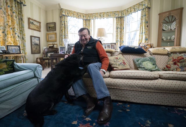 Nicky Henderson at home with his dog at Seven Barrows on Monday
