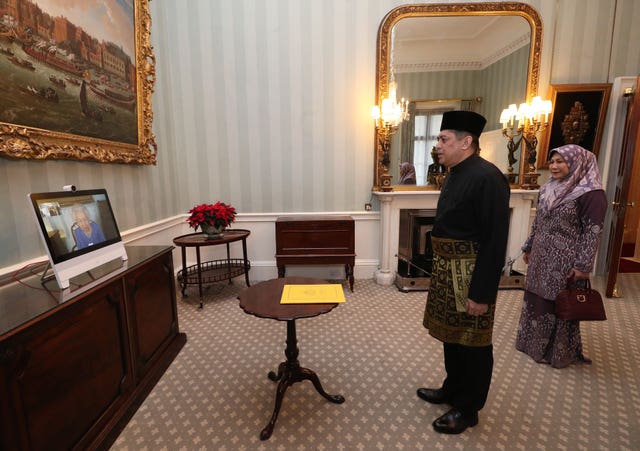 Queen Elizabeth holds a virtual diplomatic audience with the High Commissioner for Brunei Darussalam and his wife. Yui Mok/PA Wire