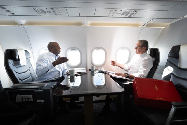 Prime Minister Sir Keir Starmer and Foreign Secretary David Lammy work on the plane as they fly to Washington DC for talks with President Joe Biden