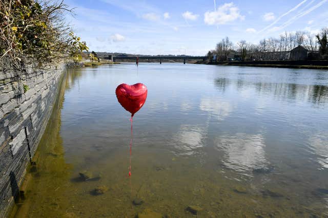A red balloon in the River Teifi in Cardigan, Wales, near the scene where two-year-old Kiara was recovered from a car (Ben Birchall/PA)