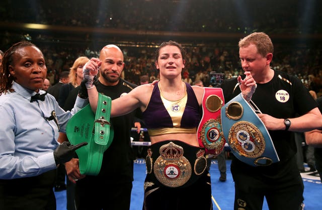 Taylor, centre, is the undisputed lightweight champion (Nick Potts/PA)