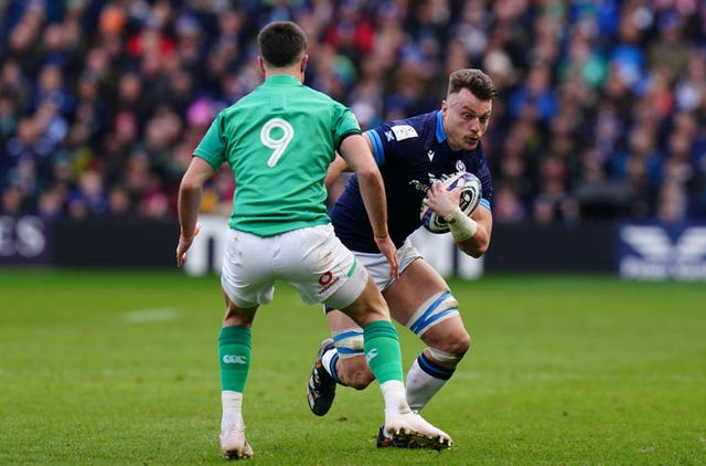 Jack Dempsey, right, runs at Ireland's Conor Murray