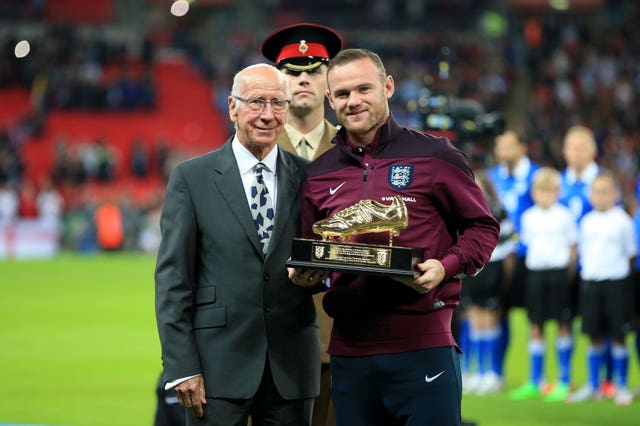 Charlton makes a presentation to Wayne Rooney at Wembley to mark the latter becoming England's all-time leading goalscorer (Nick Potts/PA).