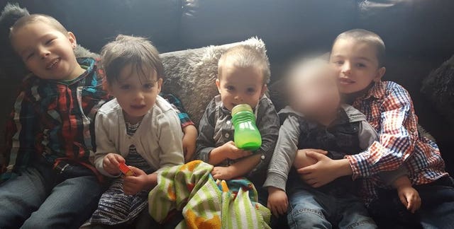 Keegan Unitt, six, left, Tilly Unitt, four, Olly Unitt, three, and their older brother Riley Holt, eight far right, pictured with a younger sibling, second right