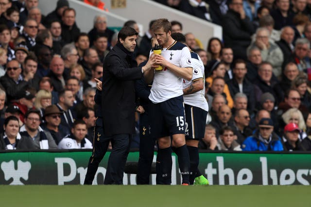 Eric Dier, right, speaks to Mauricio Pochettino