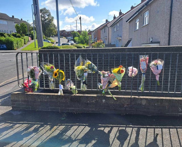 Floral tributes left at the scene in Heights Drive, Wortley, Leeds