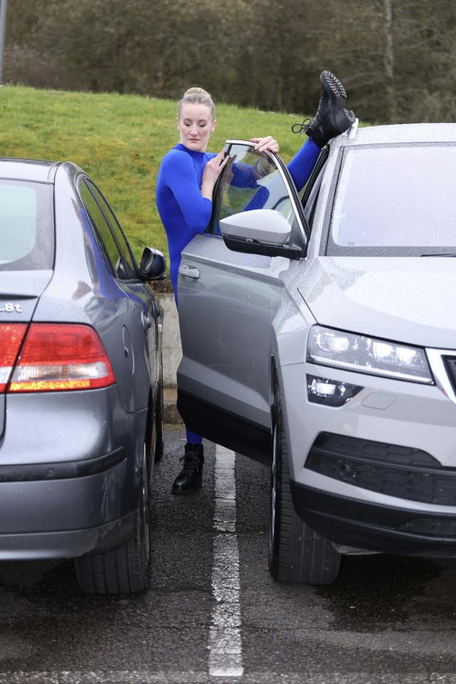 Contortionist Sally Miller attempts to get out of a parked car following research from Churchill Motor Insurance finding that drivers have just 30cm space in car parks