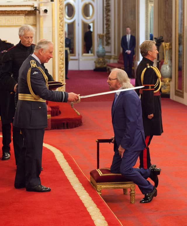 Singer and songwriter Barry Gibb is knighted by the Prince of Wales 