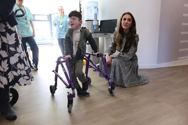 Kate crouching down to meet a youngster as she visits Ty Hafan Children’s Hospice 