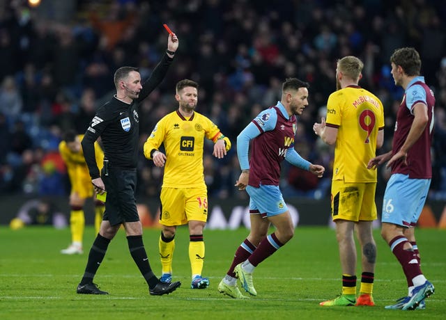 Sheffield United’s Oli McBurnie, second right, is shown a red card against Burnley