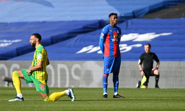 Wilfried Zaha opts not to take a knee ahead of Crystal Palace's game against West Brom in mid-March. Premier League players and officials performed the anti-racism act ahead of every game for the duration of the season. Palace forward Zaha became the first top-flight player to remain standing since play resumed last June, citing the ineffectiveness of the gesture. 