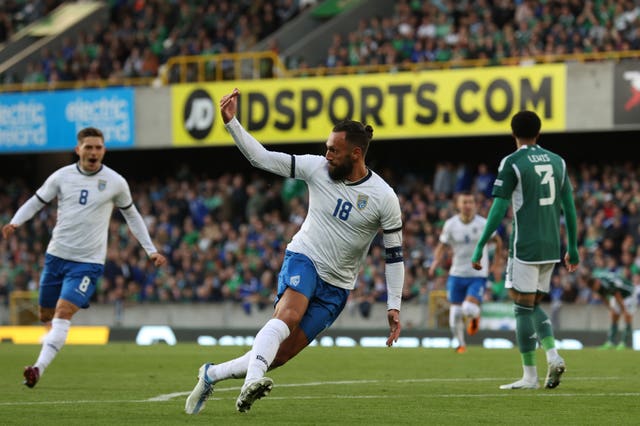 Vedat Muriqi, centre, celebrates after scoring the opening goal