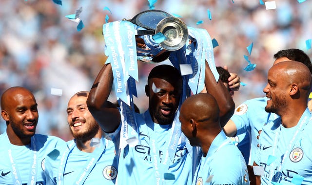 Manchester City’s Yaya Toure (centre) celebrates with the Premier League Trophy (Dave Thompson/Empics)