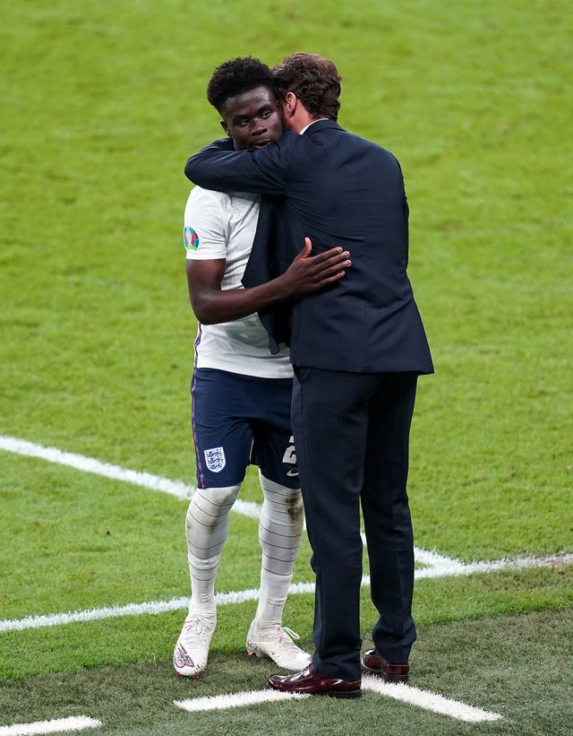 England manager Gareth Southgate consoles Bukayo Saka after his Euro 2020 final shootout miss