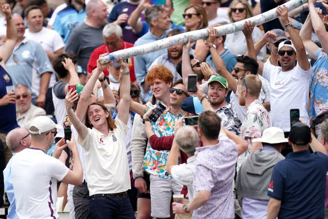 Fans in the Edgbaston stands make a beer snake out of empty plastic pint cups